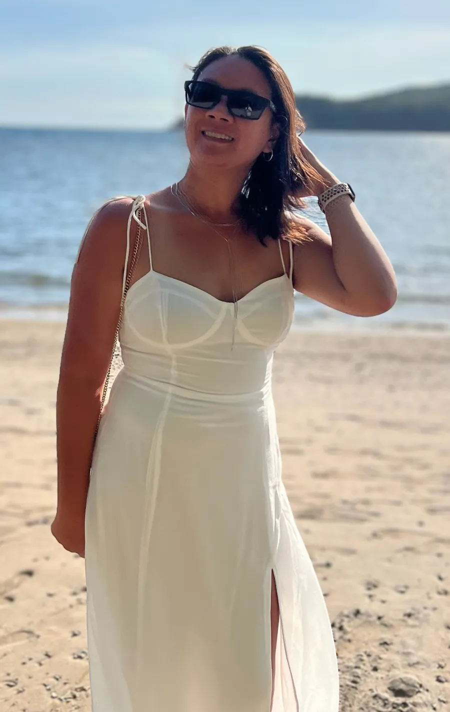 Nicole on a beach, smiling